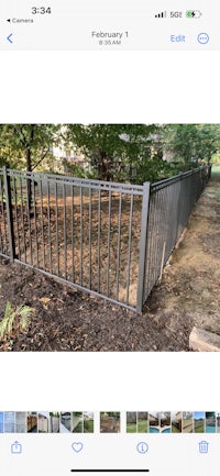 a photo of a metal fence in a yard