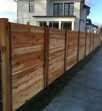 a wooden fence in front of a house