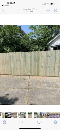 a picture of a wooden fence in a yard