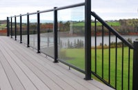 a glass railing on a deck overlooking a field